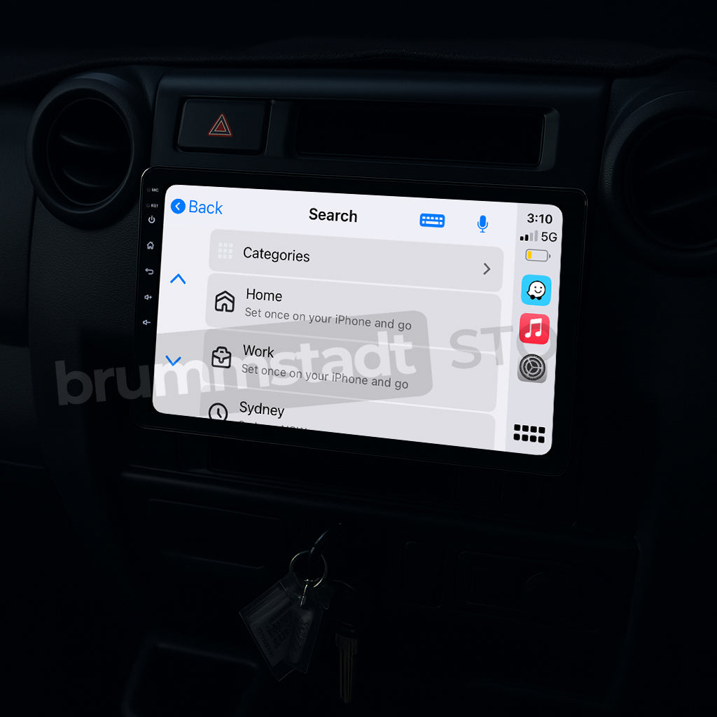 Brummstadt, Toyota Land Cruiser 70 1984-2025, showcasing Apple CarPlay interface, Toyota Land Cruiser 70 features a sleek infotainment display with visible apps like Home, Work, and Sydney, time displayed as 3:10, 5G network signal, battery status, and back button, enhancing user experience with intuitive navigation and connectivity options.