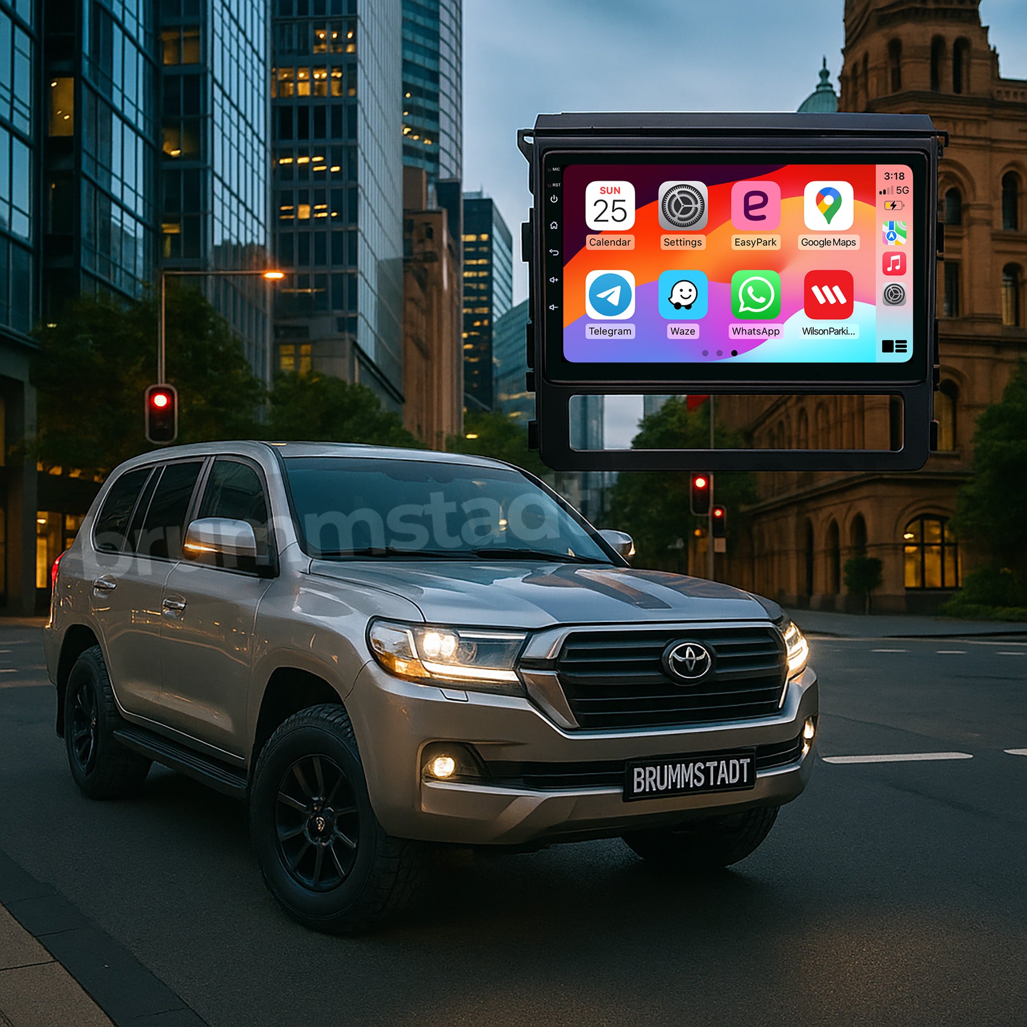 Silver Toyota Land Cruiser 200 Series SUV on a city street with a large digital display showing app icons, Apple CarPlay and Android Auto. Brummstadt.